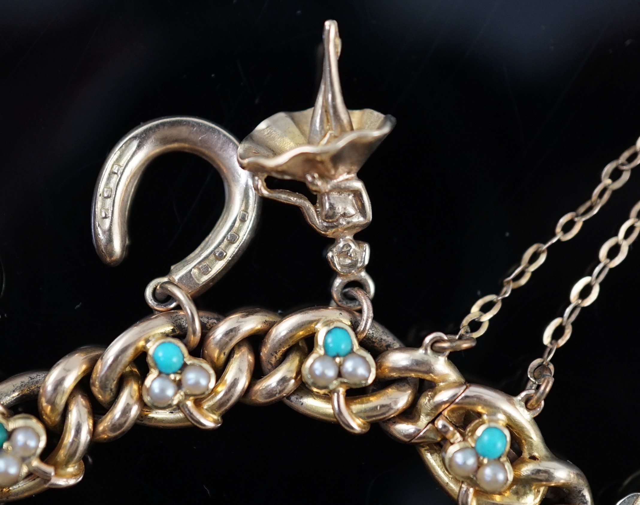 An Edwardian 15ct gold, seed pearl and turquoise set curb link charm bracelet